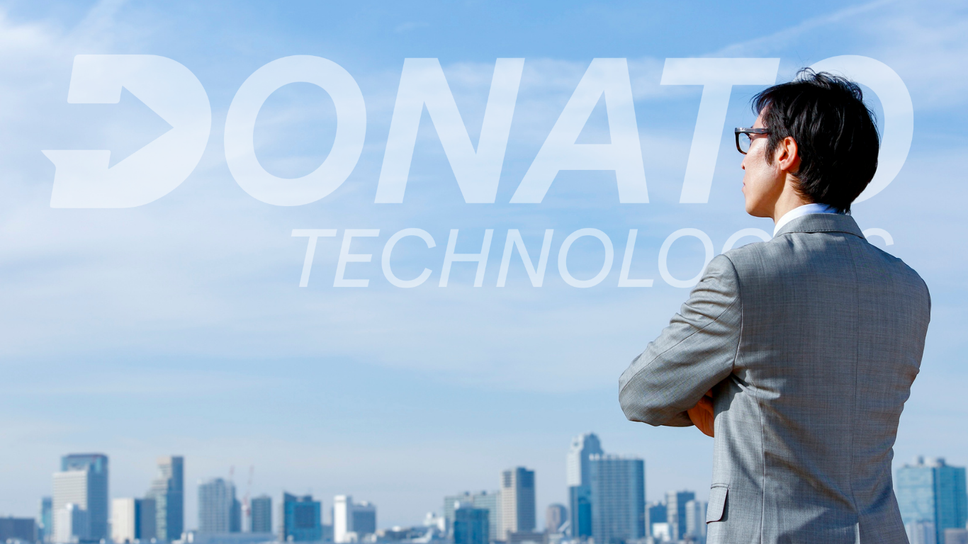 Professional standing confidently while looking into a futuristic landscape with the Donato Technologies logo shining in the sky, symbolizing career growth and opportunity